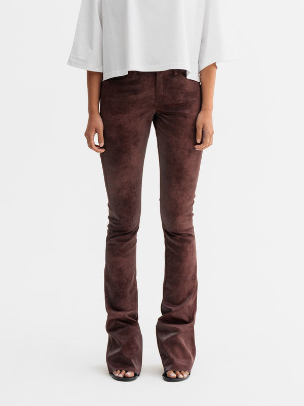 Model wearing Ahlvar Gallery Aiko PU leather trousers in Burgundy