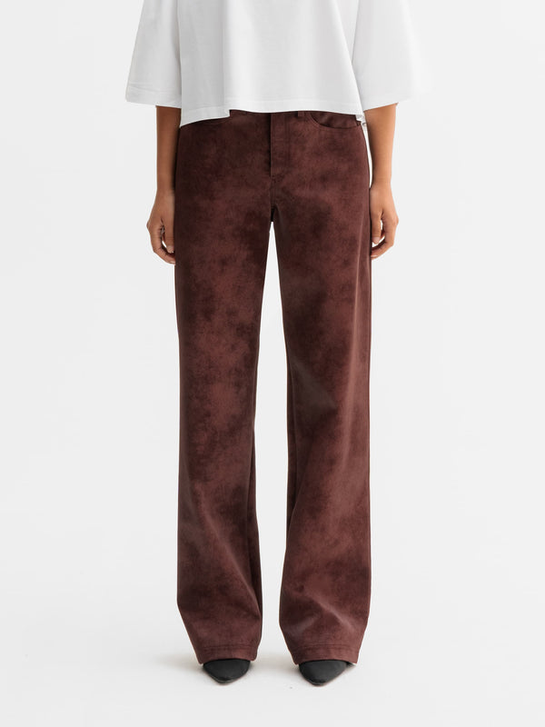Model wearing Ahlvar Gallery Aina PU leather trousers in Burgundy