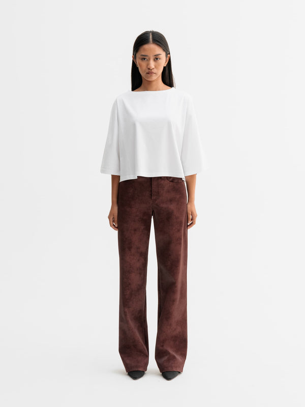 Model wearing Ahlvar Gallery Aina PU leather trousers in Burgundy