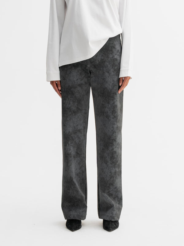 Model wearing Ahlvar Gallery Aina PU leather trousers in Dark grey