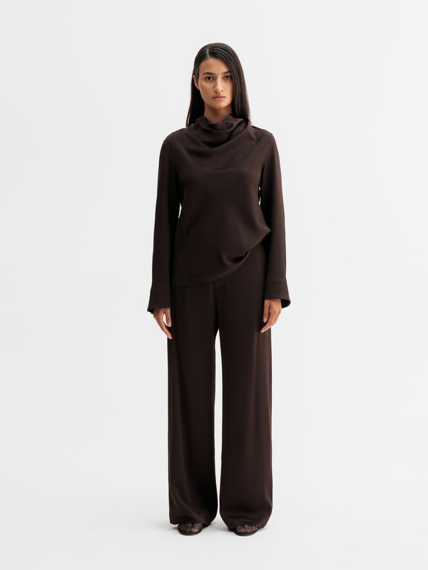 Model wearing Ahlvar Gallery Ari blouse in Dark brown