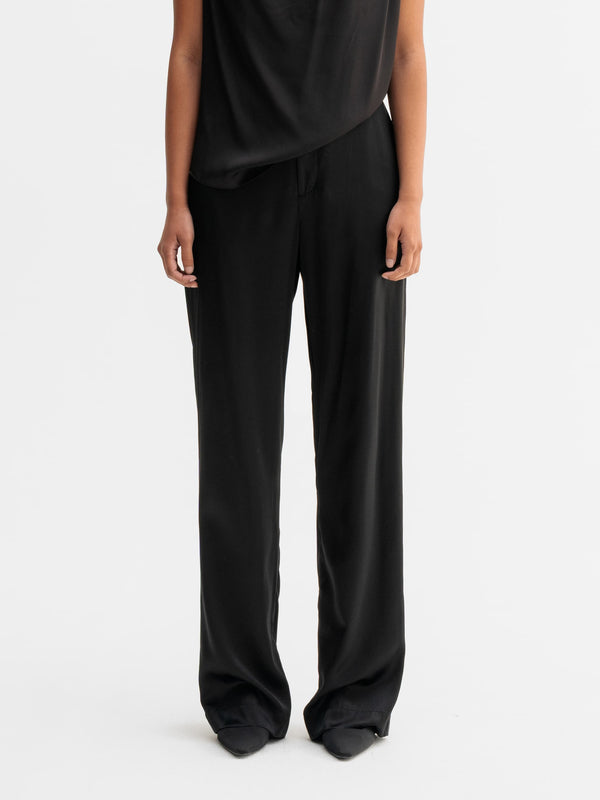 Model wearing Ahlvar Gallery Ava satin silk trousers in Black