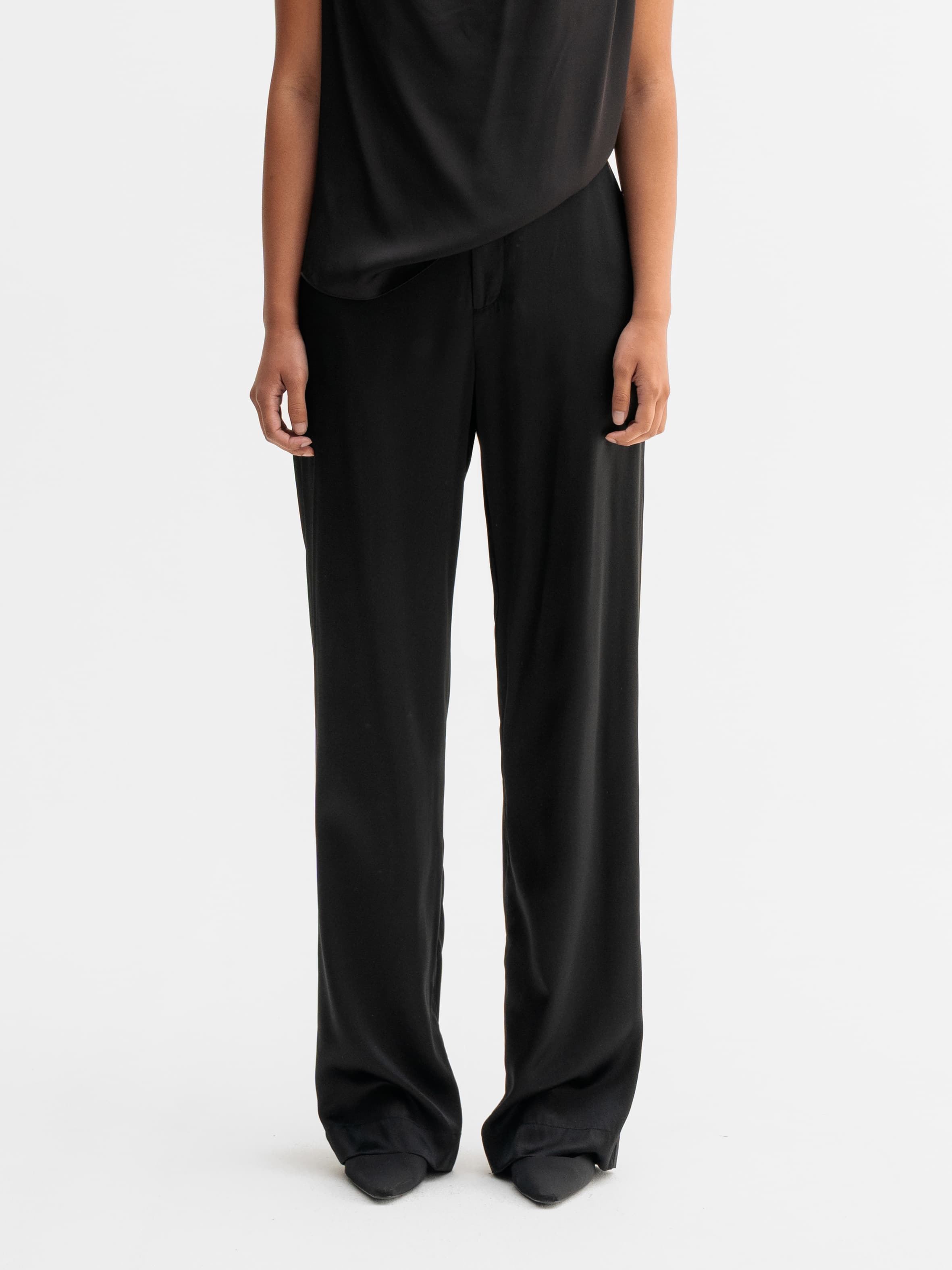 Model wearing Ahlvar Gallery Ava satin silk trousers in Black