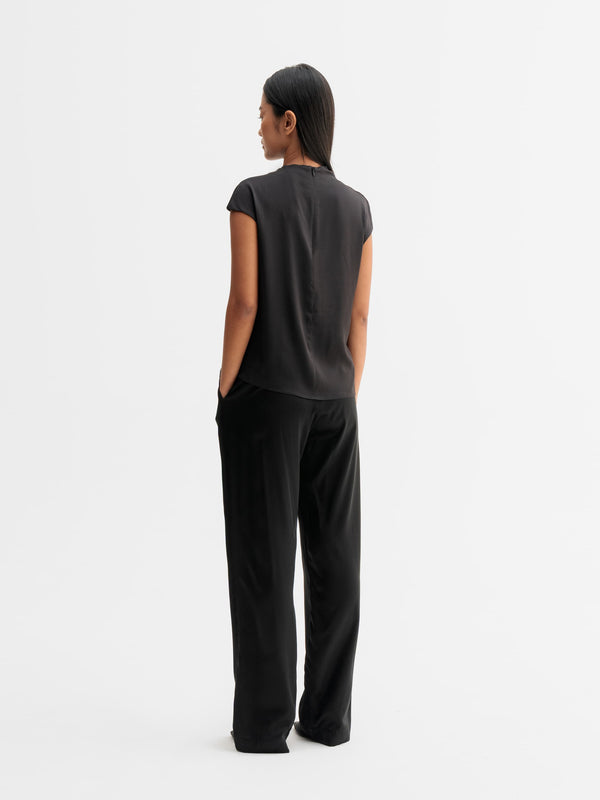 Back view of Ahlvar Gallery Ava satin silk trousers in Black