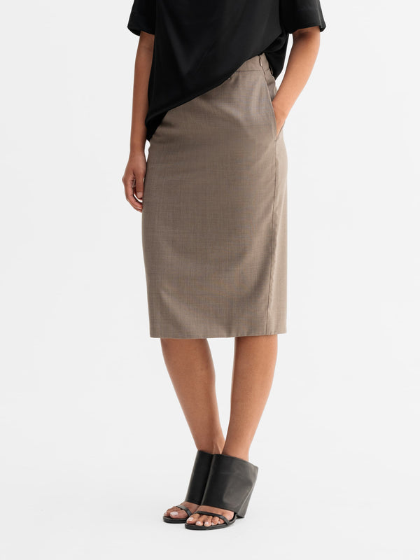 Model wearing Ahlvar Gallery Ava wool skirt in Light brown