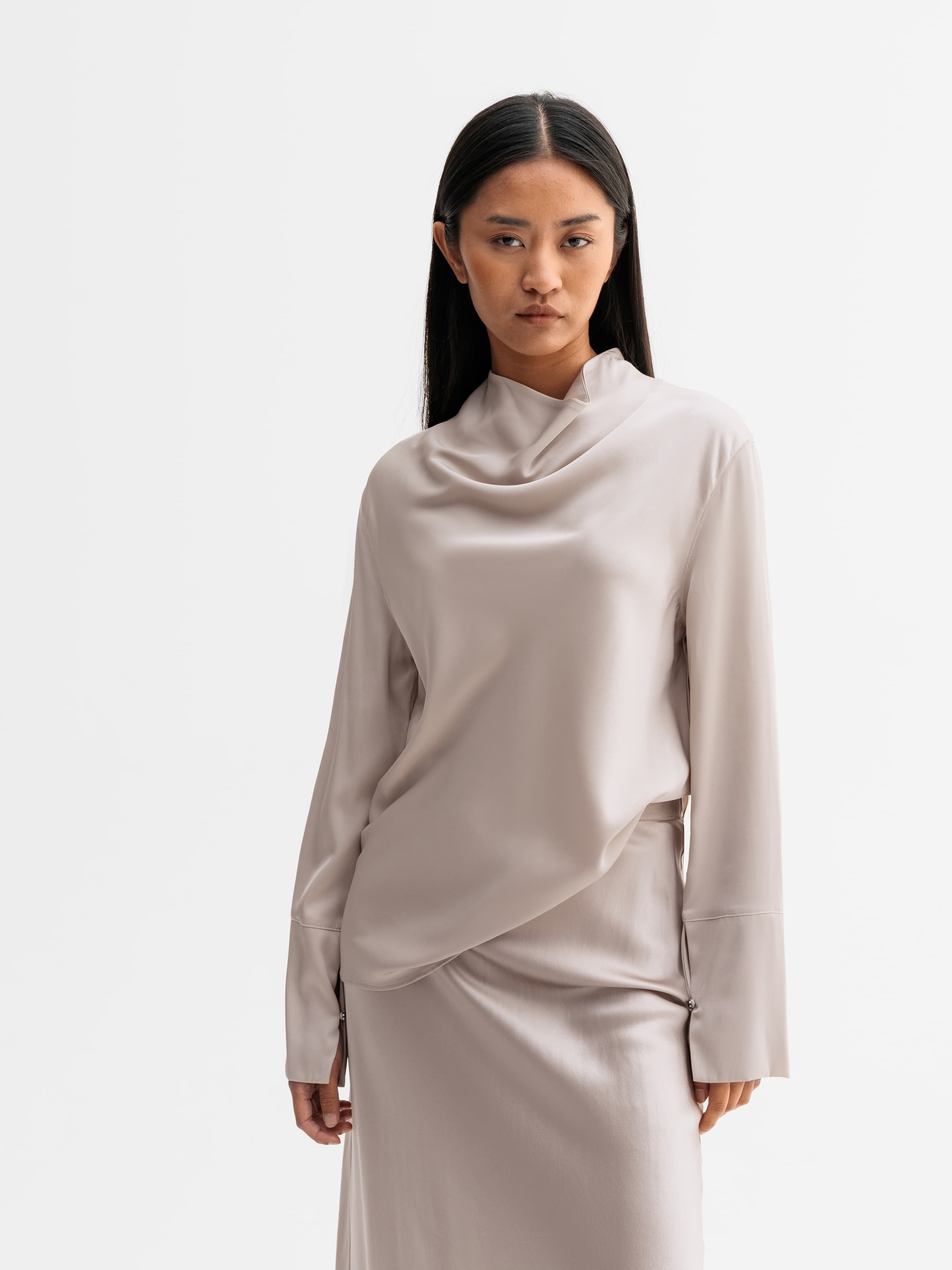 Model wearing Ahlvar Gallery Ayumi silk blouse in Greige