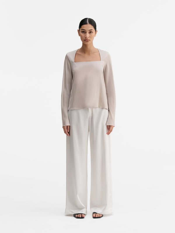 Model wearing Ahlvar Gallery Della silk blouse greige