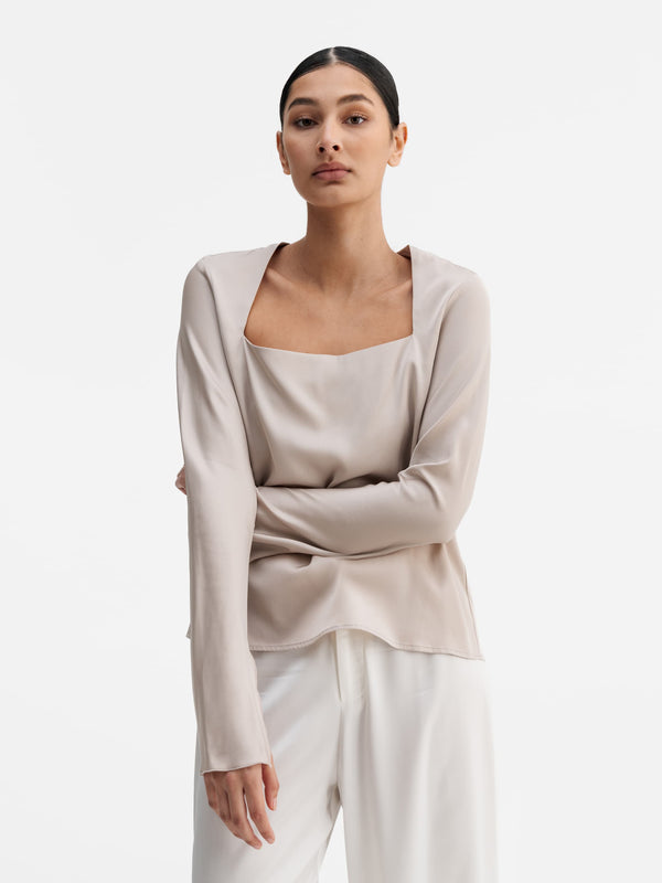 Model wearing Ahlvar Gallery Della silk blouse greige