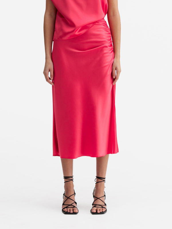 Model wearing Ahlvar Gallery Dina satin skirt bubblegum