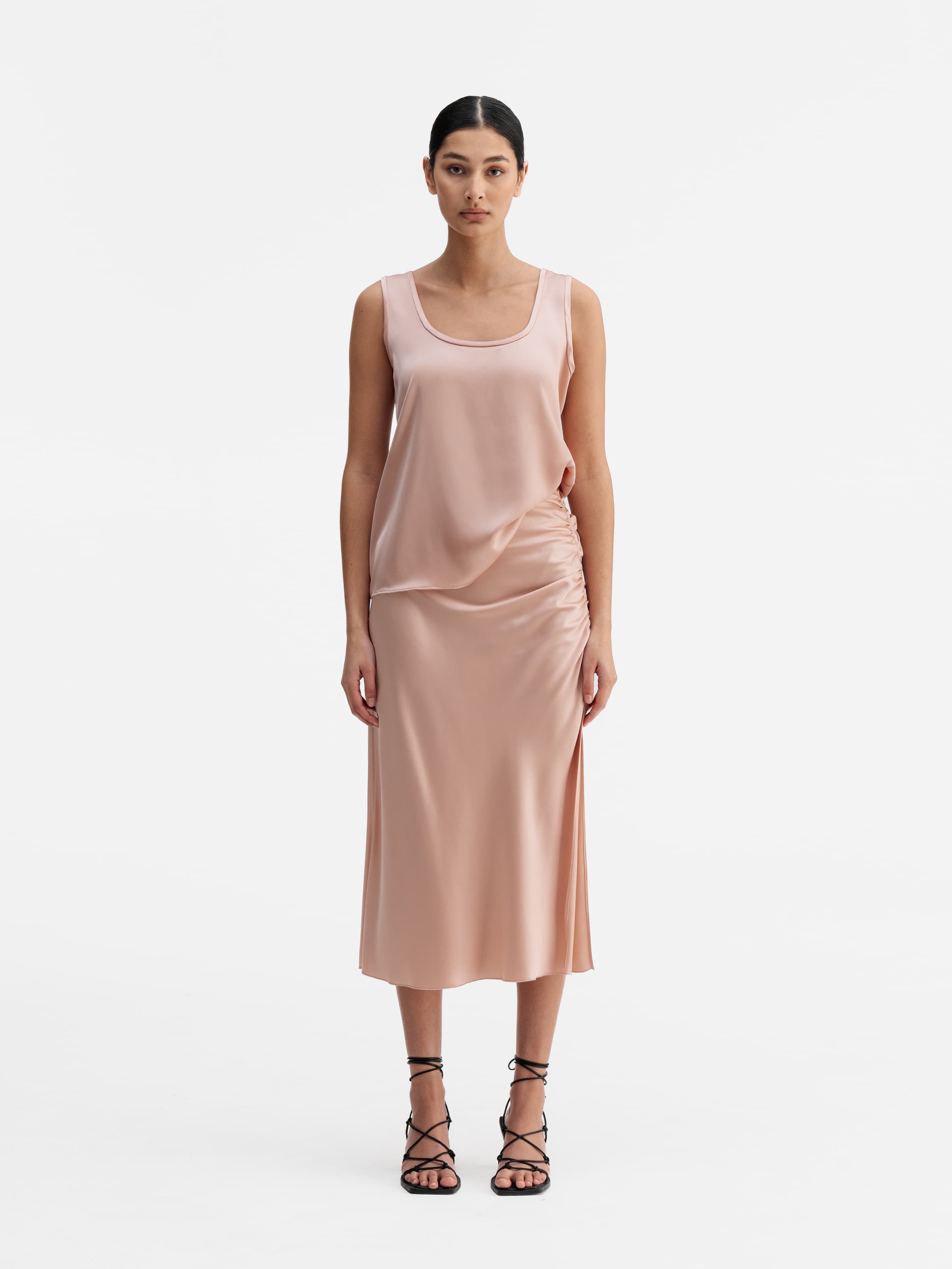 Model wearing Ahlvar Gallery Dina satin skirt dusty pink