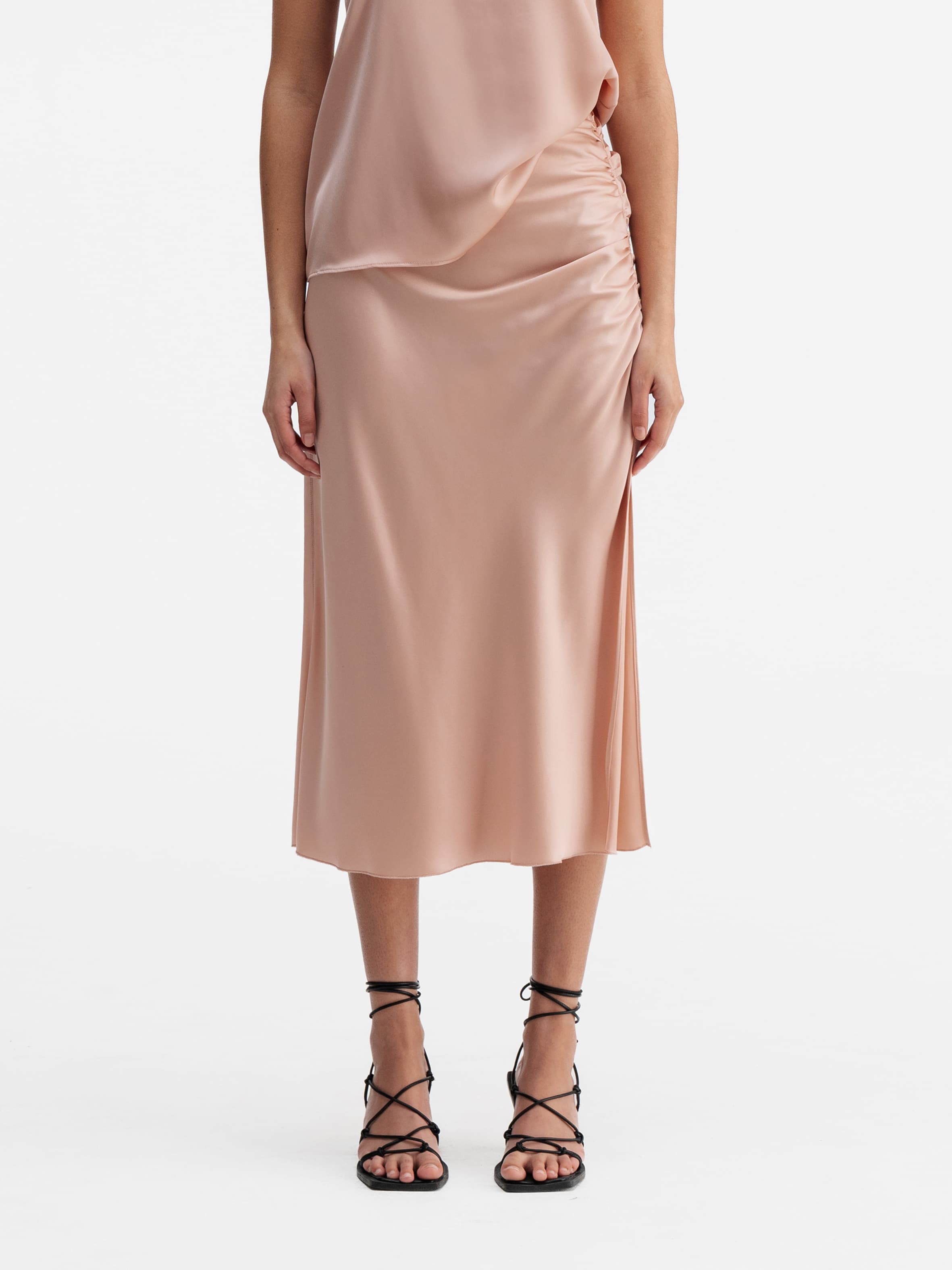 Model wearing Ahlvar Gallery Dina satin skirt dusty pink