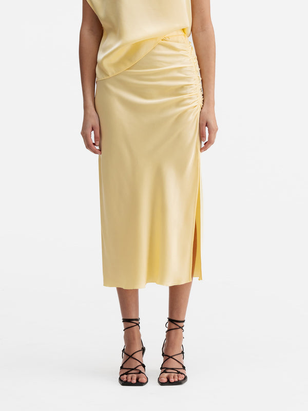 Model wearing Ahlvar Gallery Dina satin skirt light yellow