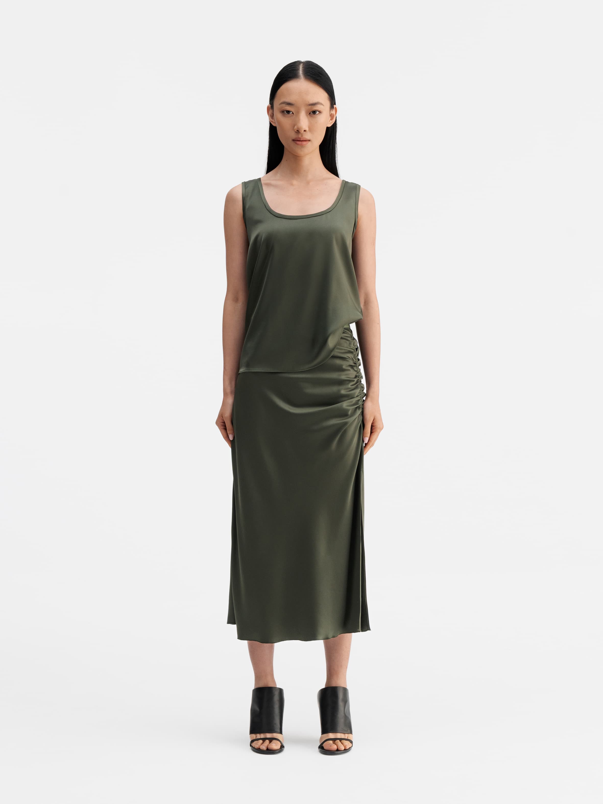 Model wearing Ahlvar Gallery Dina satin skirt olive green