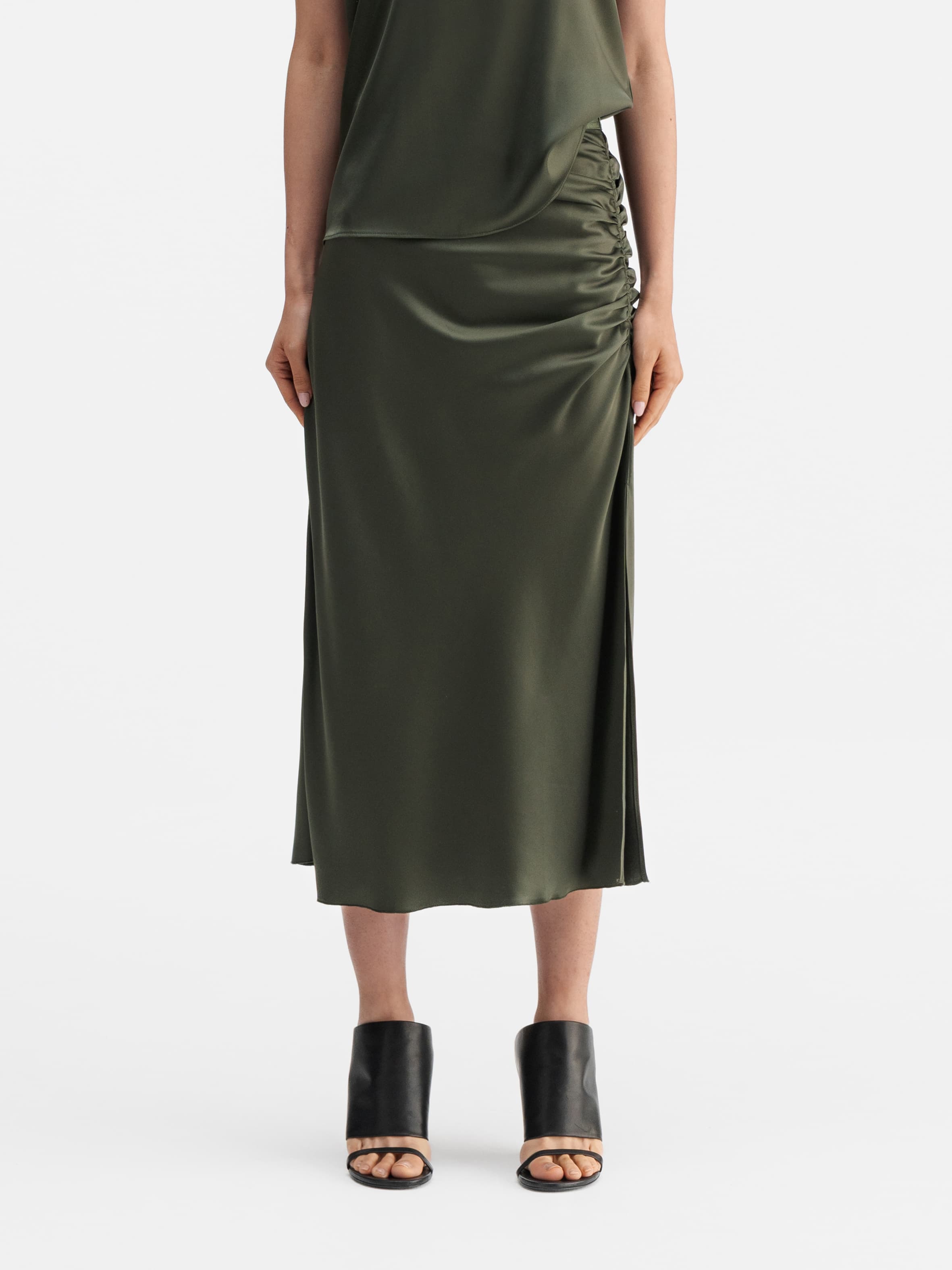 Model wearing Ahlvar Gallery Dina satin skirt olive green