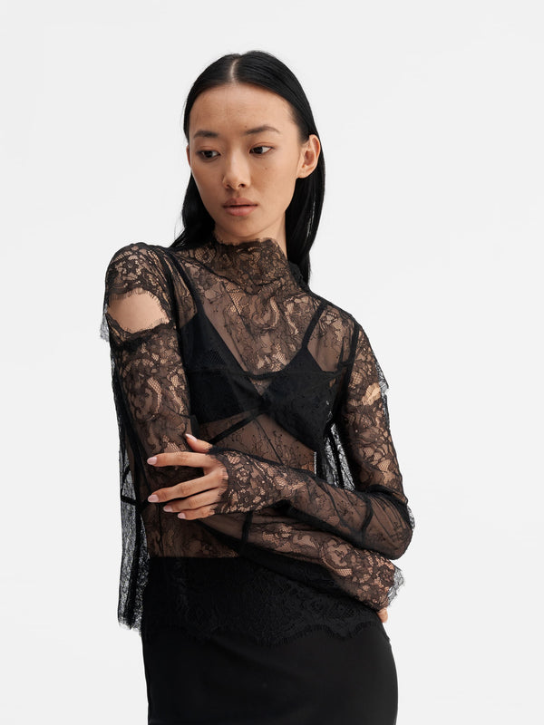 Model wearing Ahlvar Gallery Edina lace blouse black