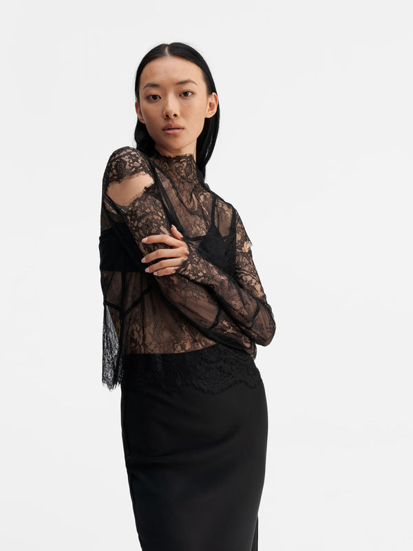 Model wearing Ahlvar Gallery Edina lace blouse black
