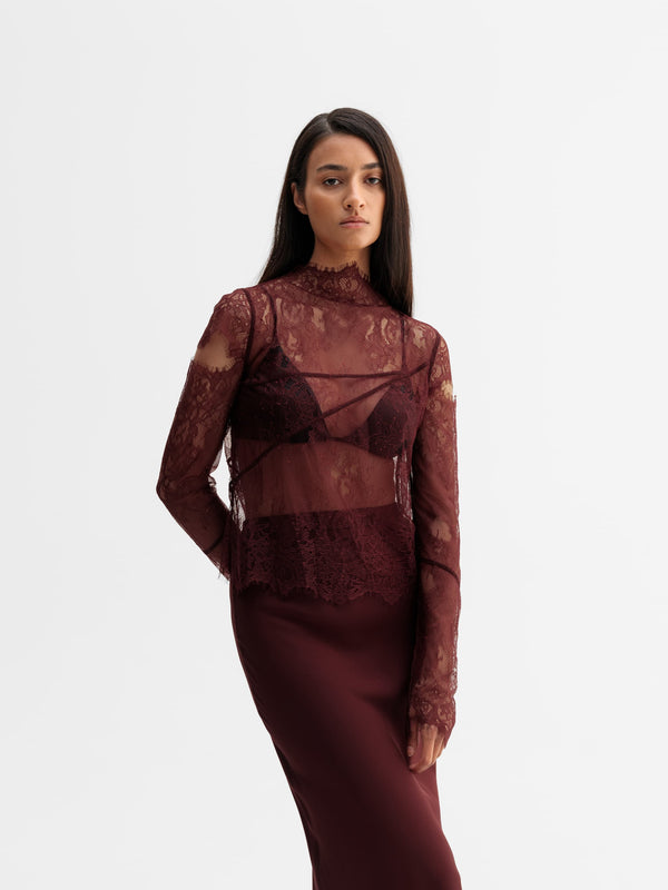 Model wearing Ahlvar Gallery Edina lace blouse in Burgundy
