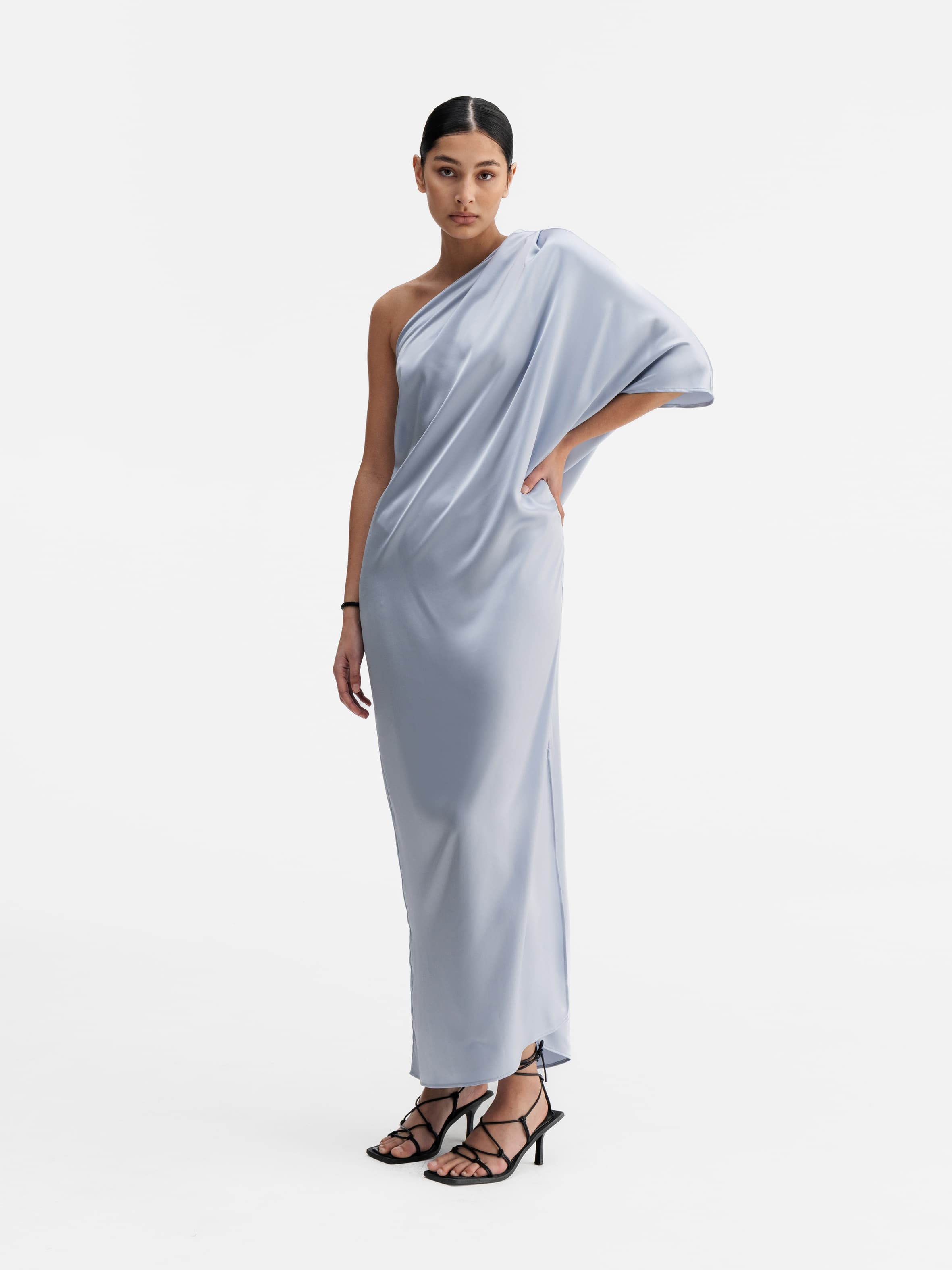 Model wearing Ahlvar Gallery Ella satin dress denim blue