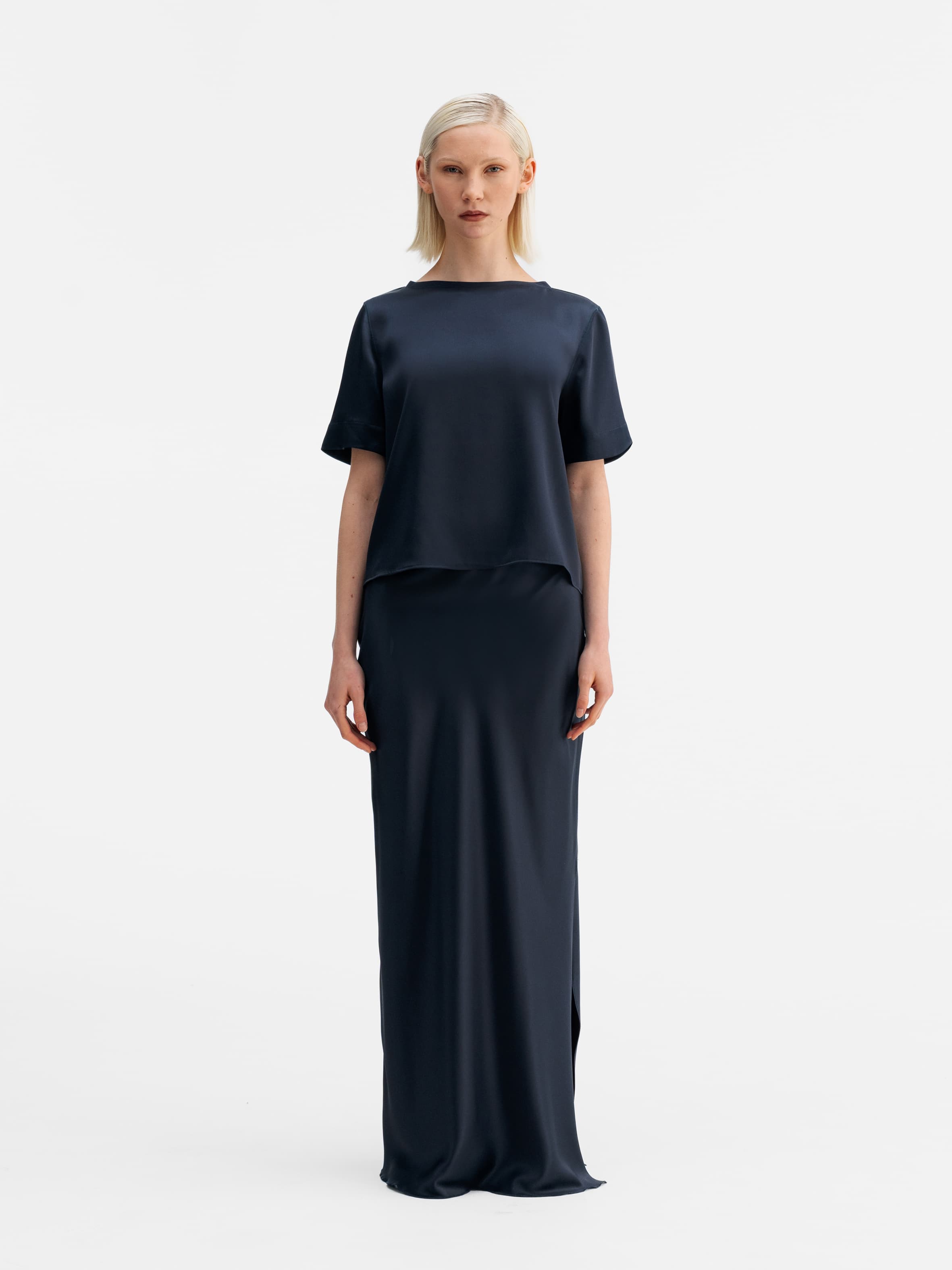 Model wearing Ahlvar Gallery Hana long logo satin skirt blue grey
