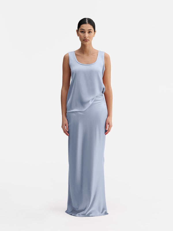 Model wearing Ahlvar Gallery Hana long logo satin skirt denim blue