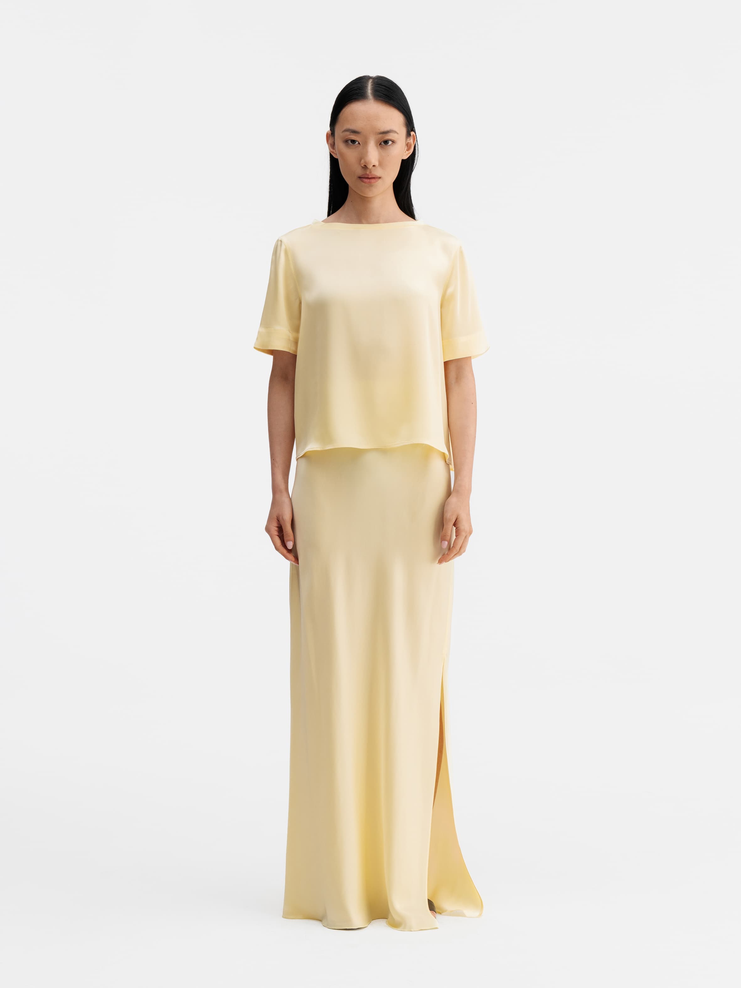 Model wearing Ahlvar Gallery Hana long logo satin skirt light yellow