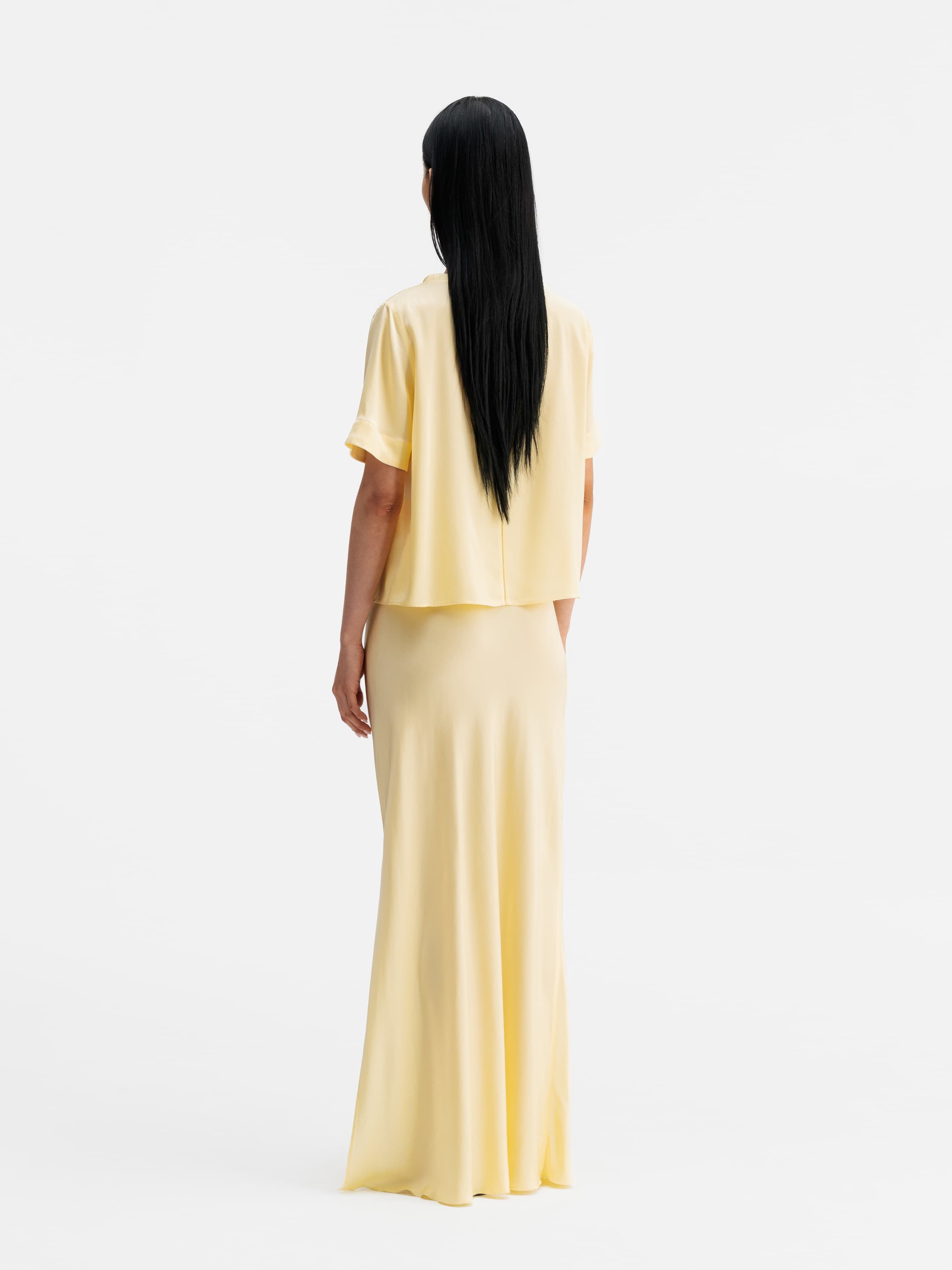 Back view of Ahlvar Gallery Hana long logo satin skirt light yellow