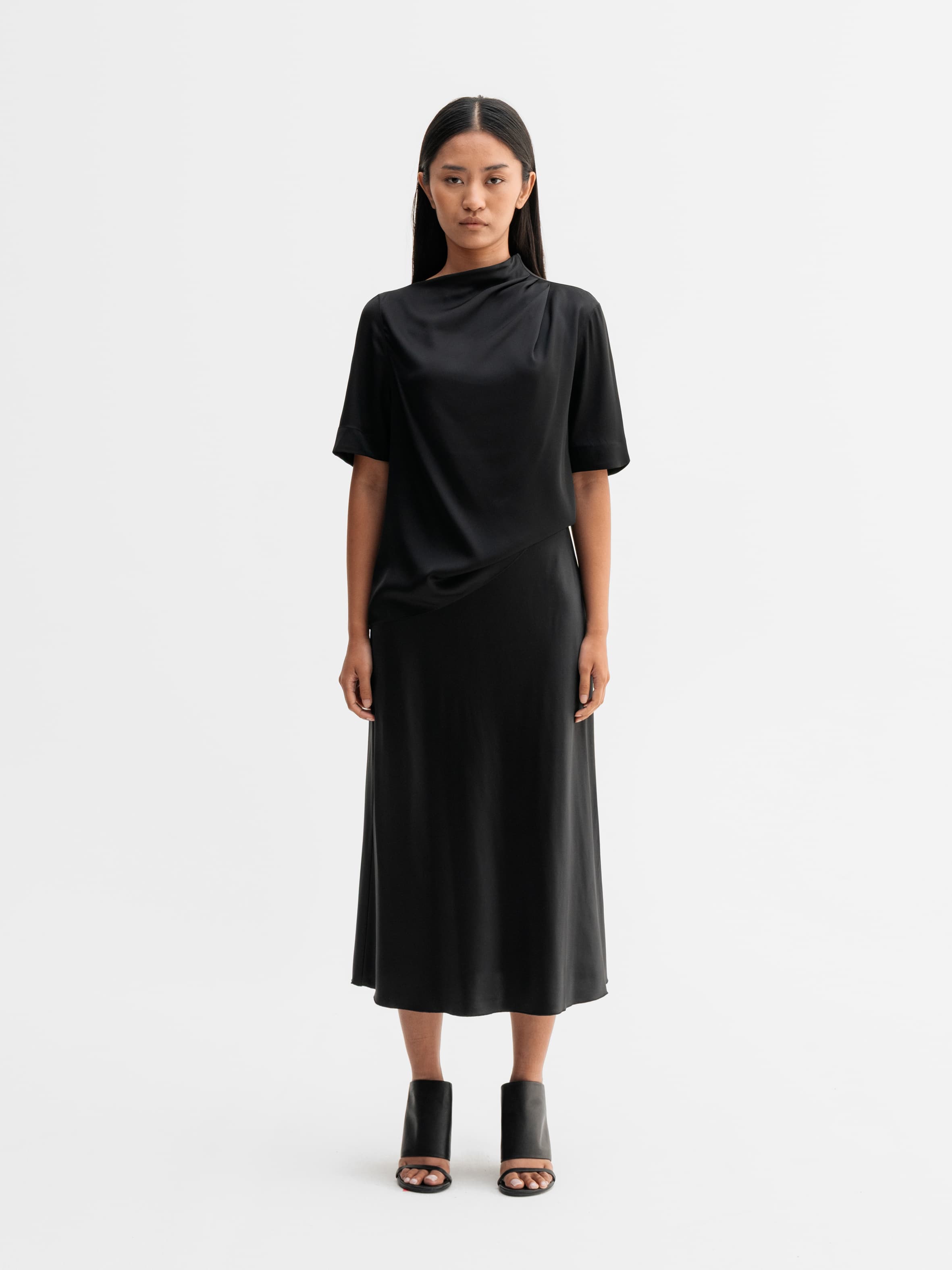 Model wearing Ahlvar Gallery Hana satin silk skirt in Black