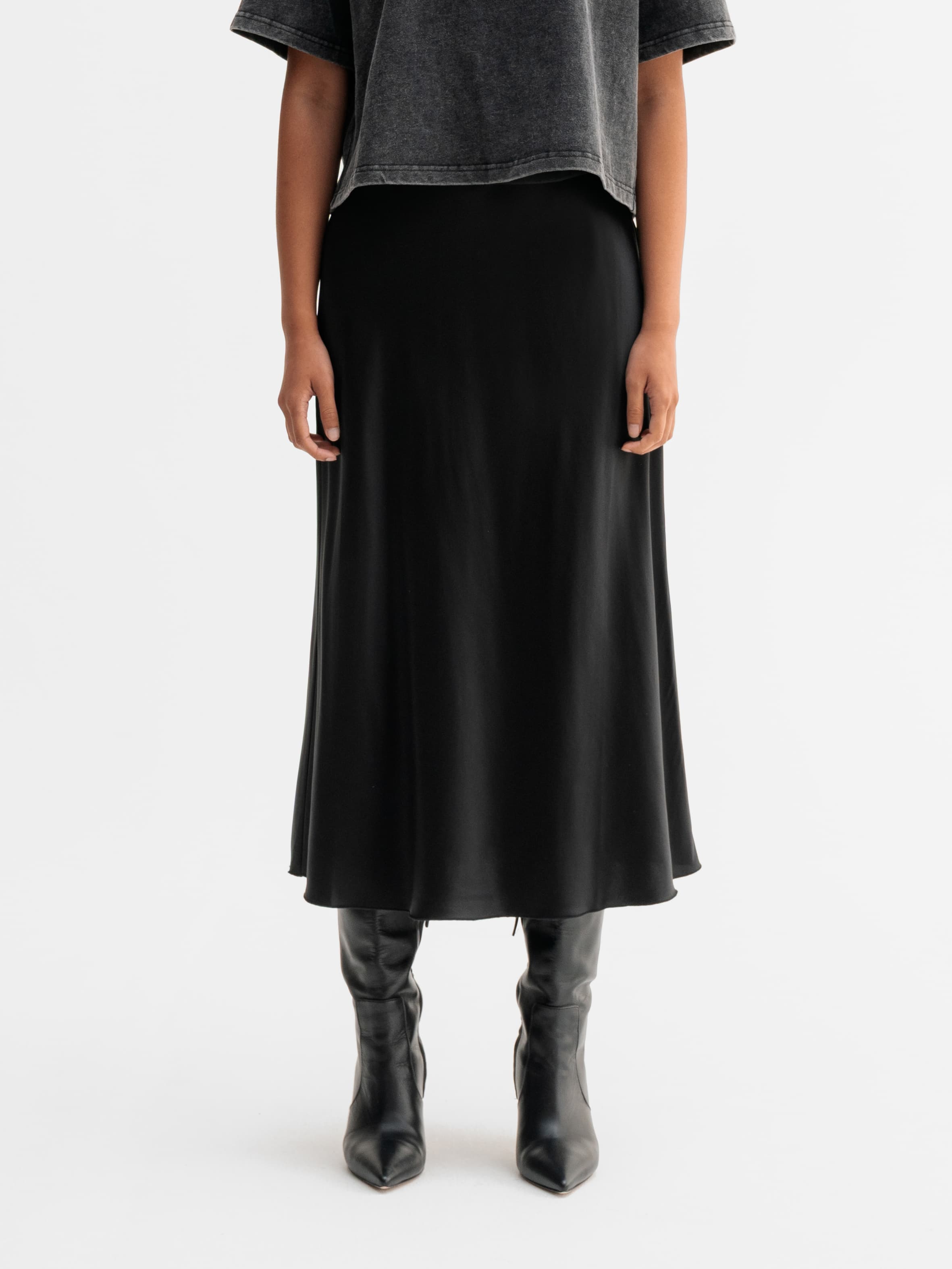 Model wearing Ahlvar Gallery Hana satin silk skirt in Black