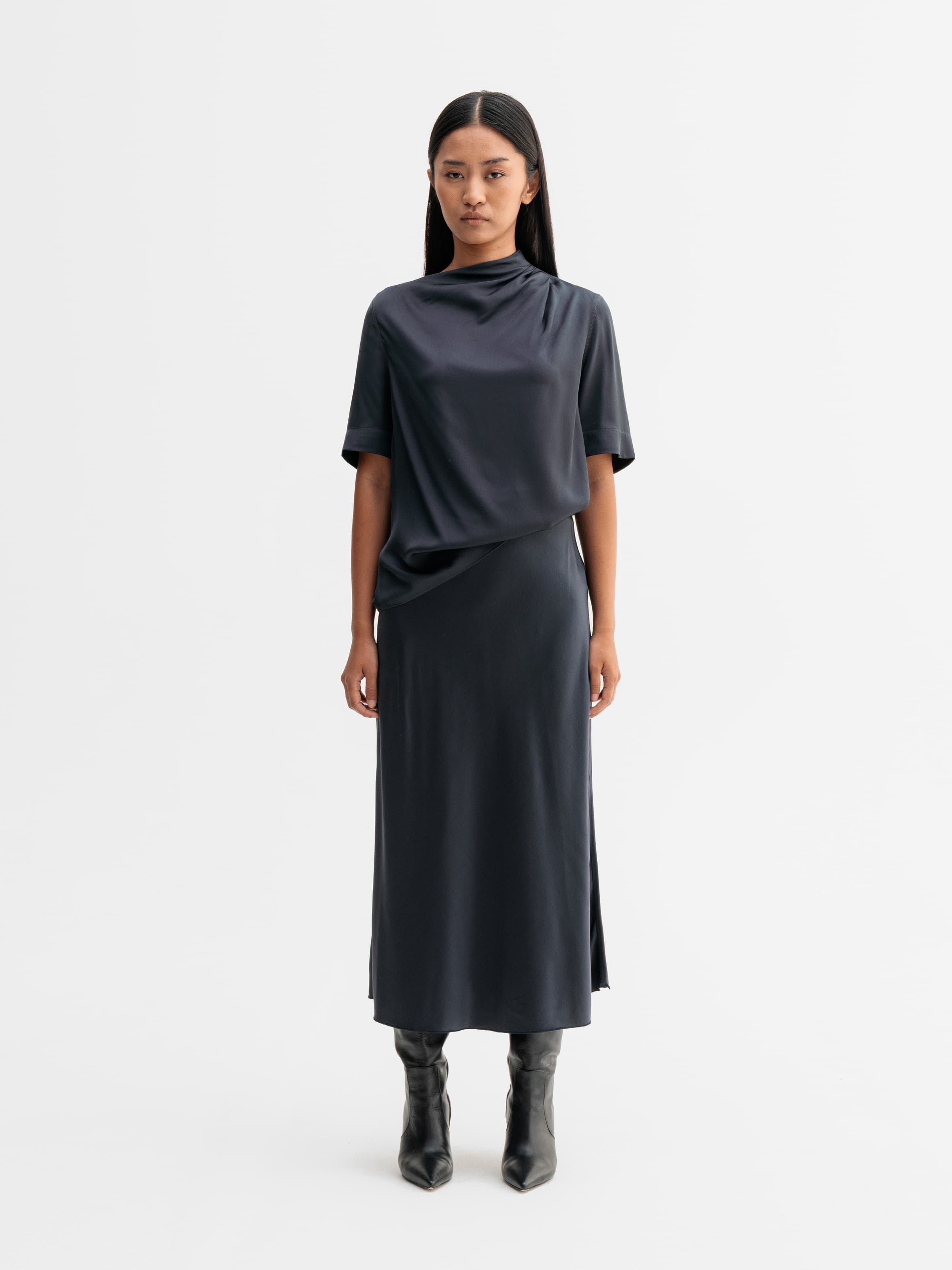 Model wearing Ahlvar Gallery Hana satin silk skirt in Blue grey