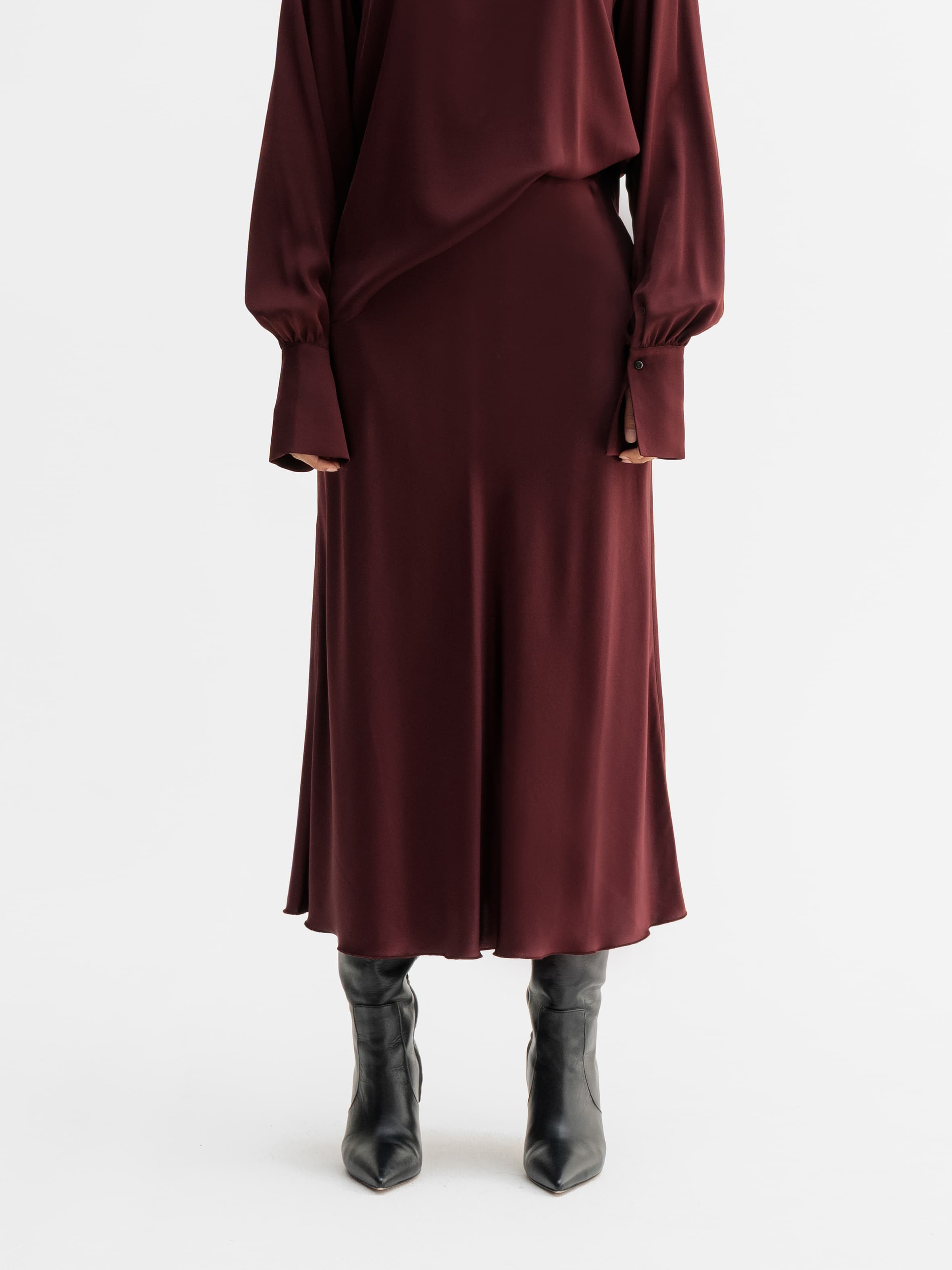 Model wearing Ahlvar Gallery Hana satin silk skirt in Burgundy