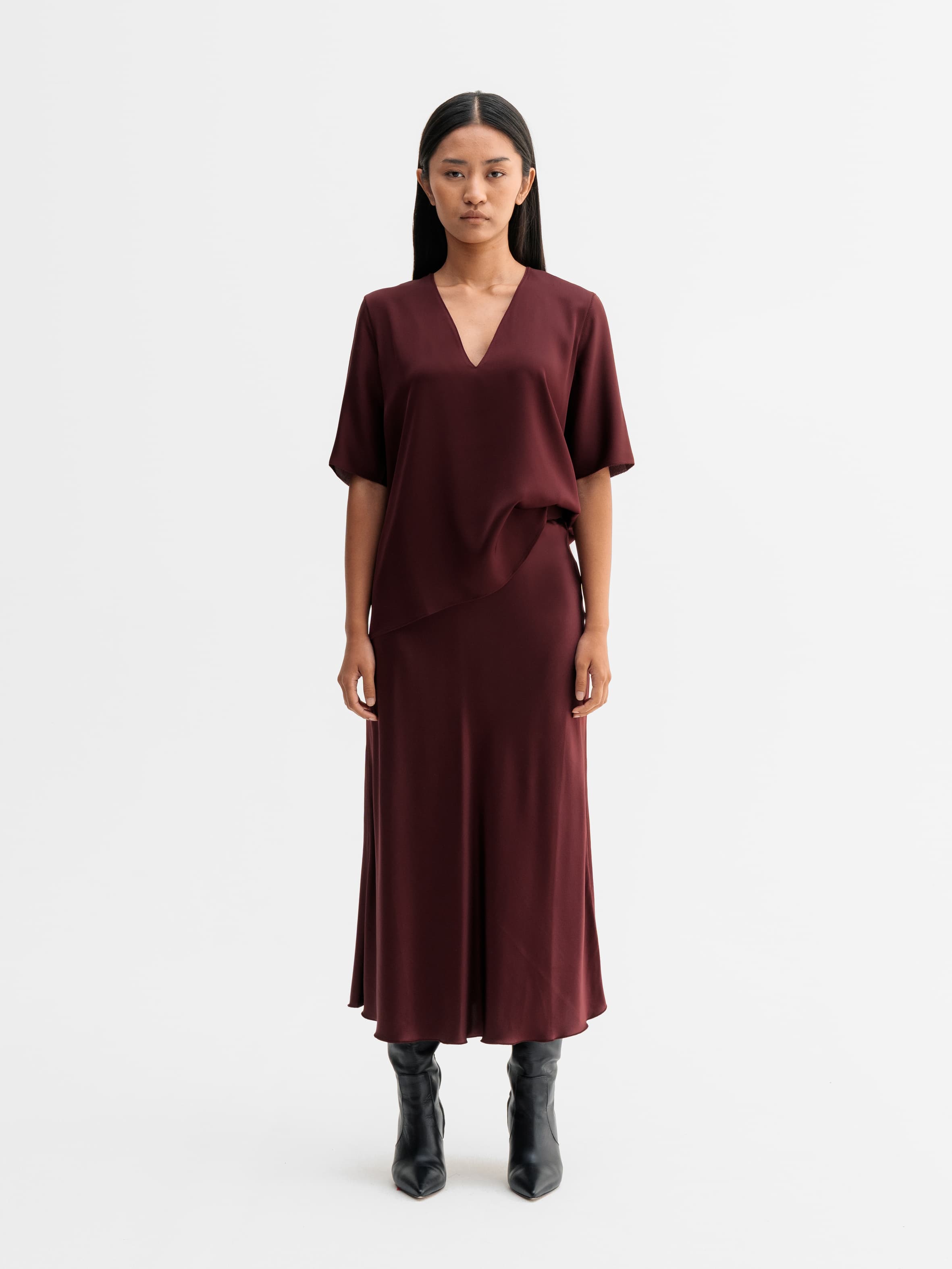 Model wearing Ahlvar Gallery Hana satin silk skirt in Burgundy