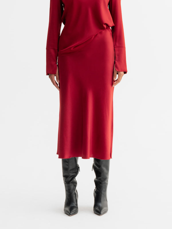 Model wearing Ahlvar Gallery Hana satin silk skirt in Dark red