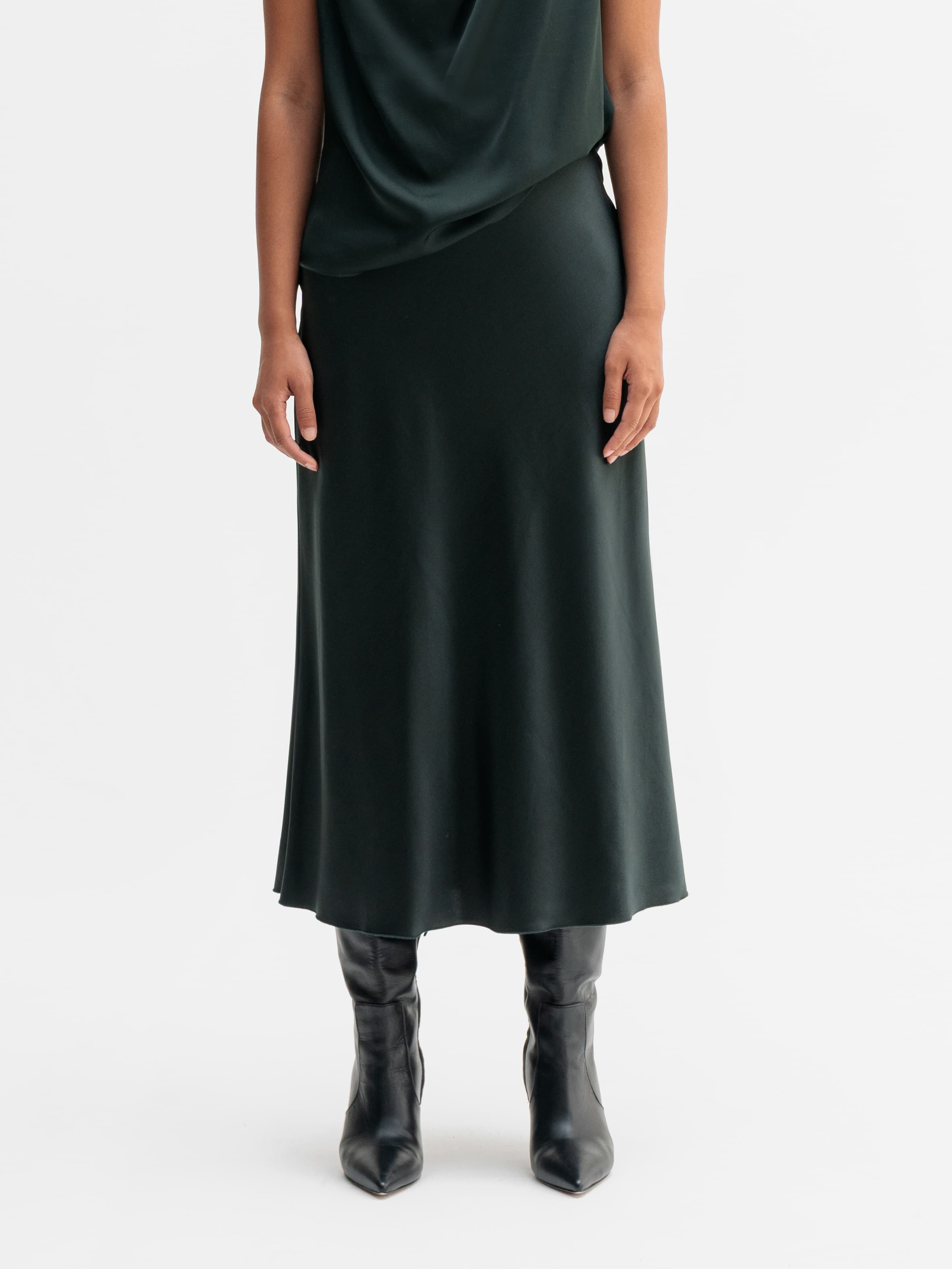 Model wearing Ahlvar Gallery Hana satin silk skirt in Deep forest