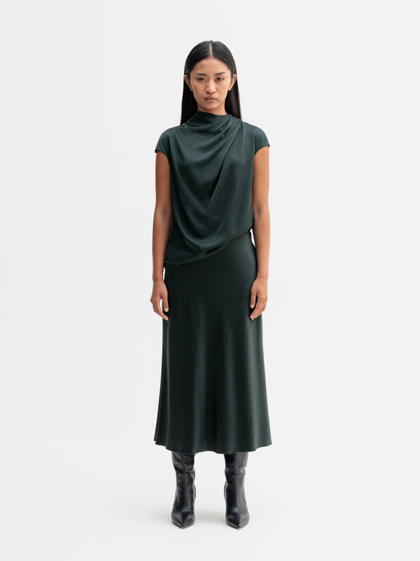 Model wearing Ahlvar Gallery Hana satin silk skirt in Deep forest