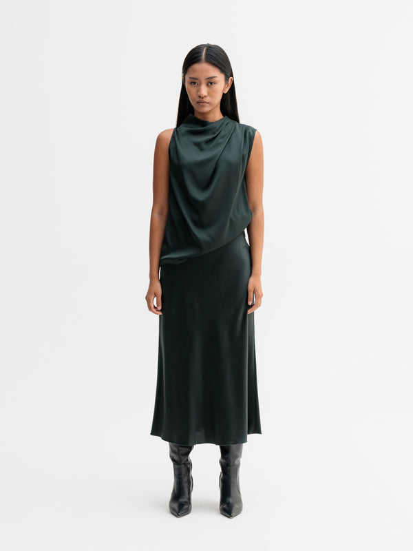 Model wearing Ahlvar Gallery Hana satin silk skirt in Deep forest