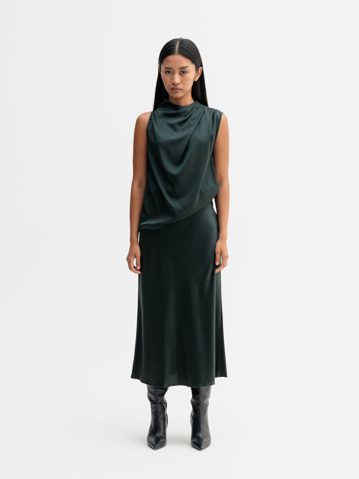 Model wearing Ahlvar Gallery Hana satin silk skirt in Deep forest