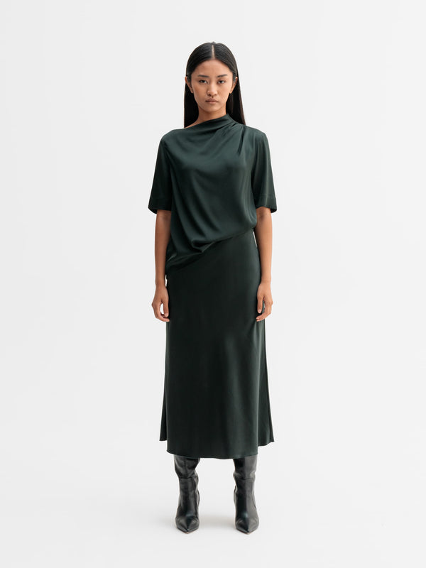 Model wearing Ahlvar Gallery Hana satin silk skirt in Deep forest