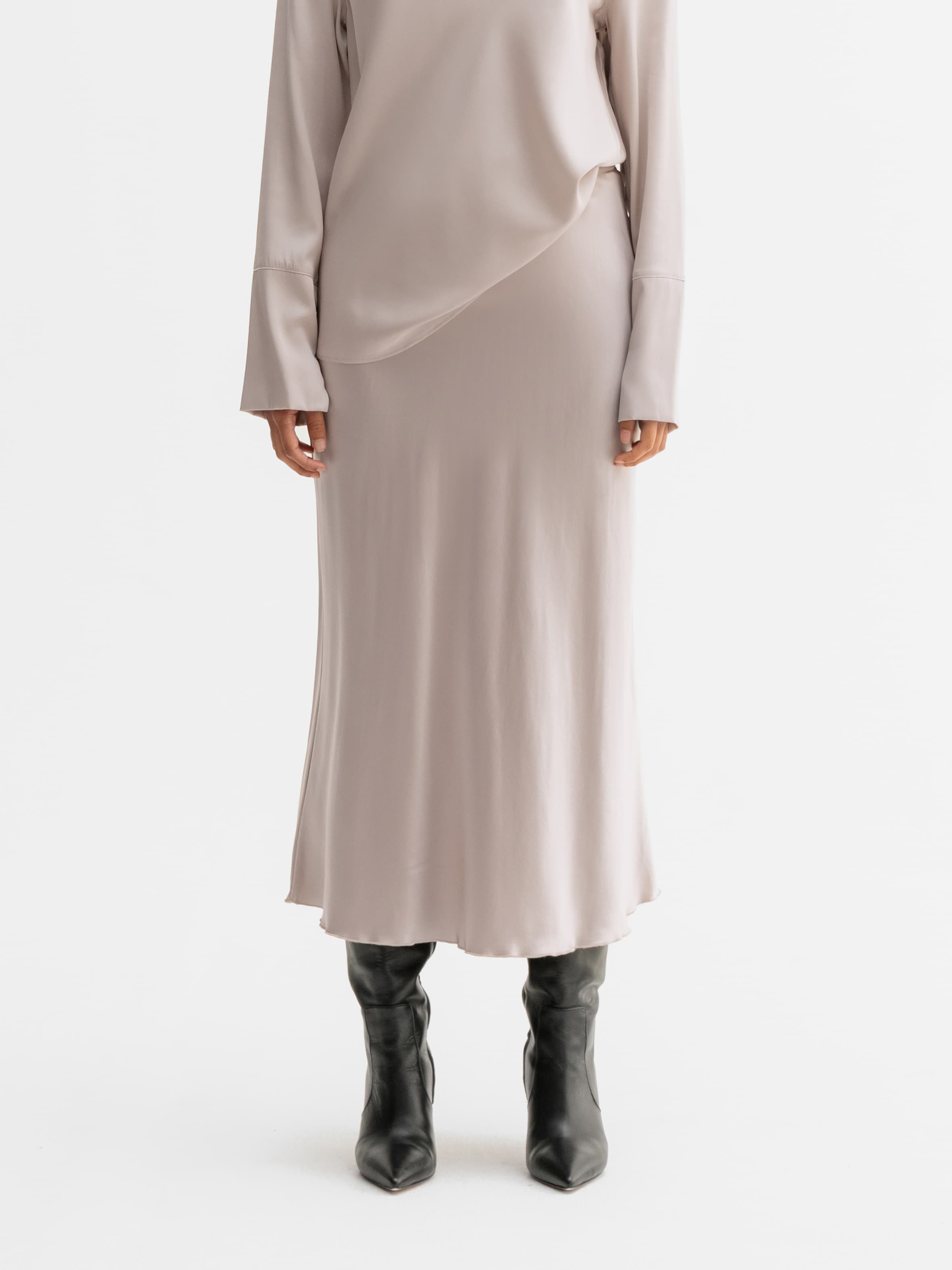 Model wearing Ahlvar Gallery Hana satin silk skirt in Greige