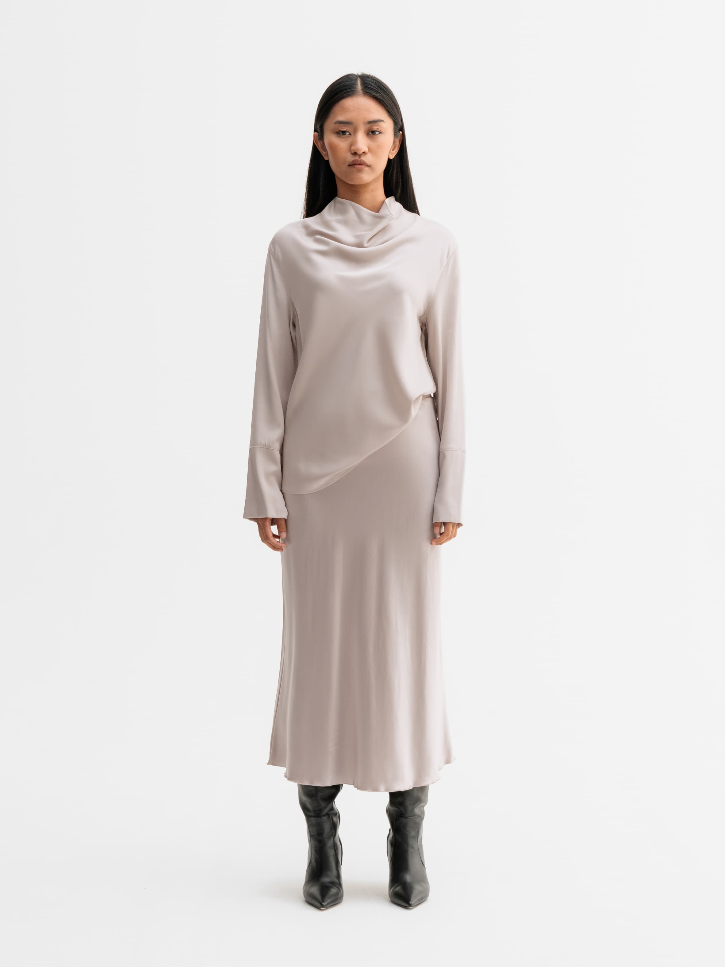 Model wearing Ahlvar Gallery Hana satin silk skirt in Greige
