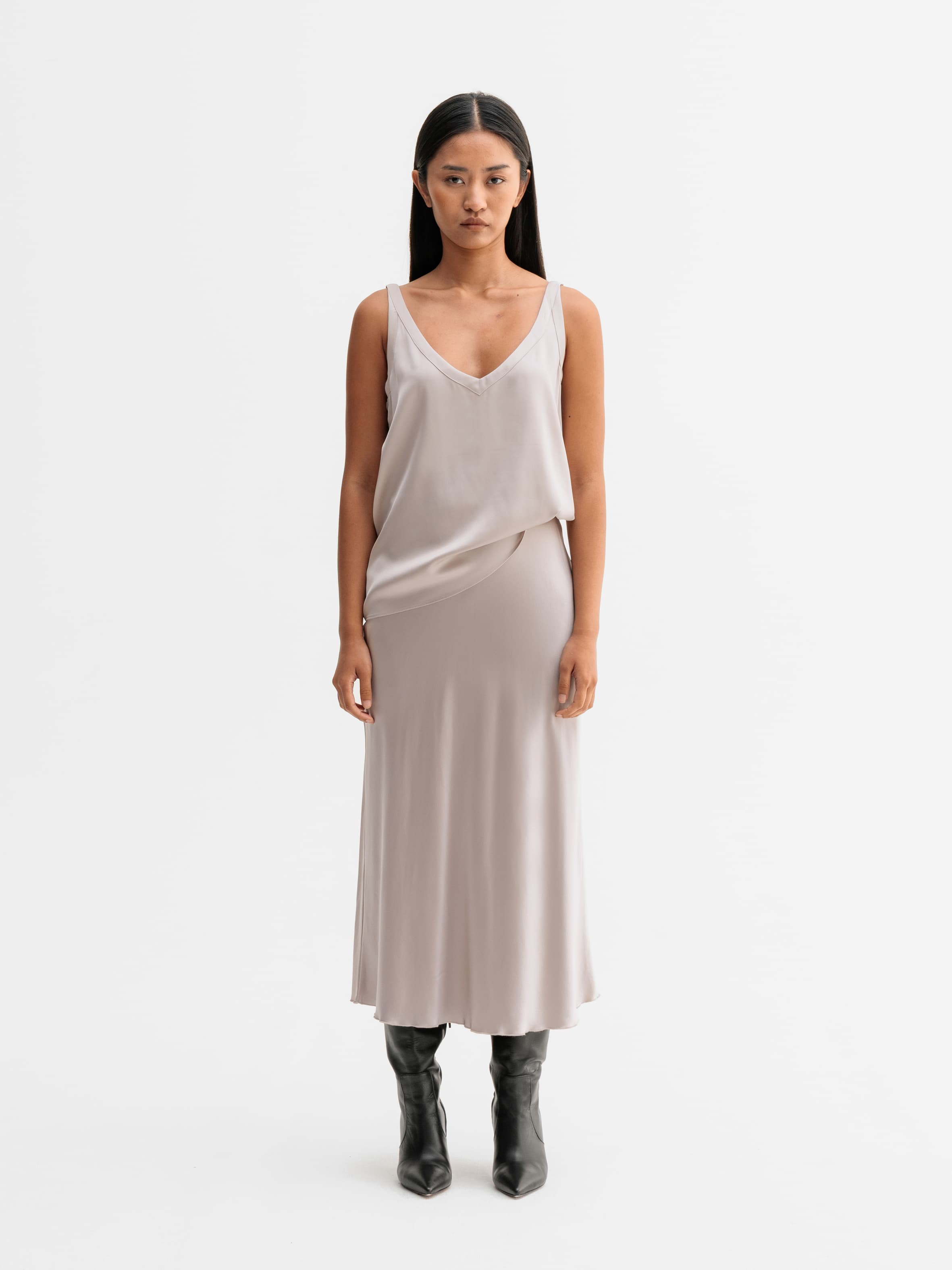 Model wearing Ahlvar Gallery Hana satin silk skirt in Greige