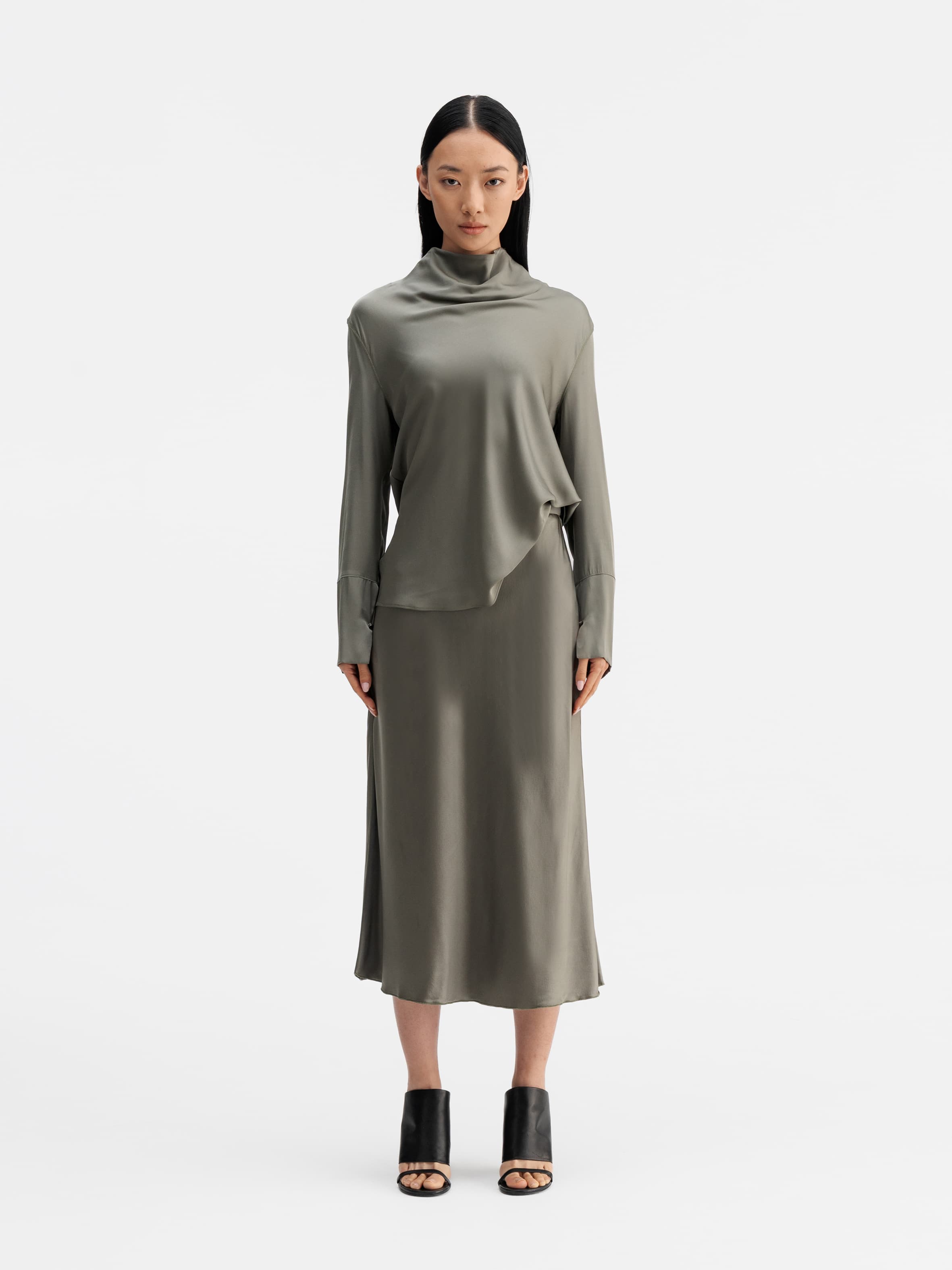 Model wearing Ahlvar Gallery Hana satin silk skirt light military