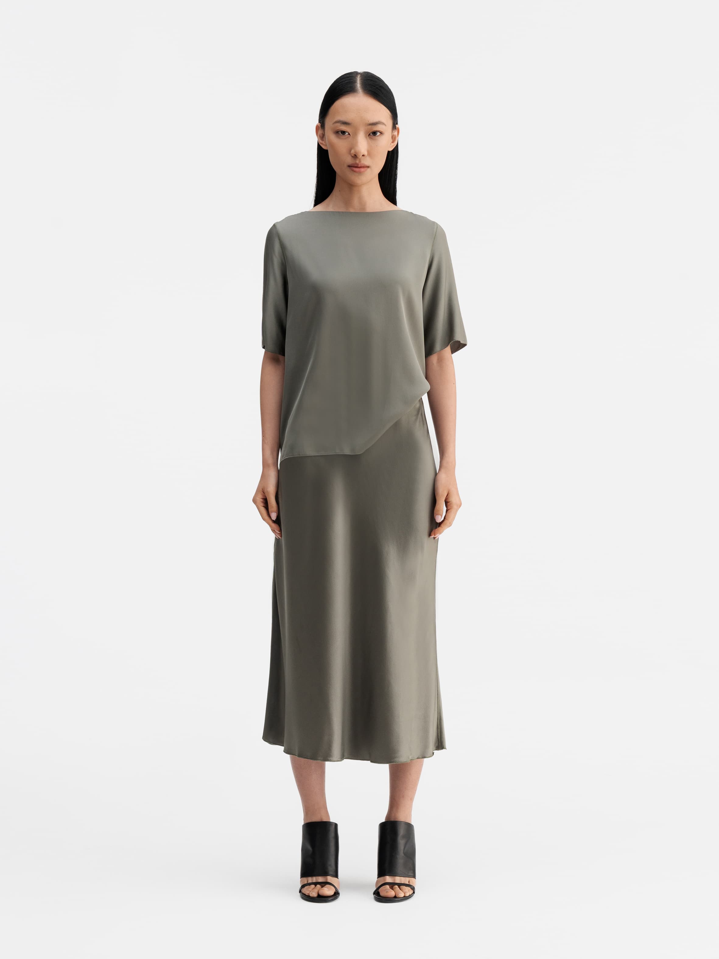 Model wearing Ahlvar Gallery Hana satin silk skirt light military