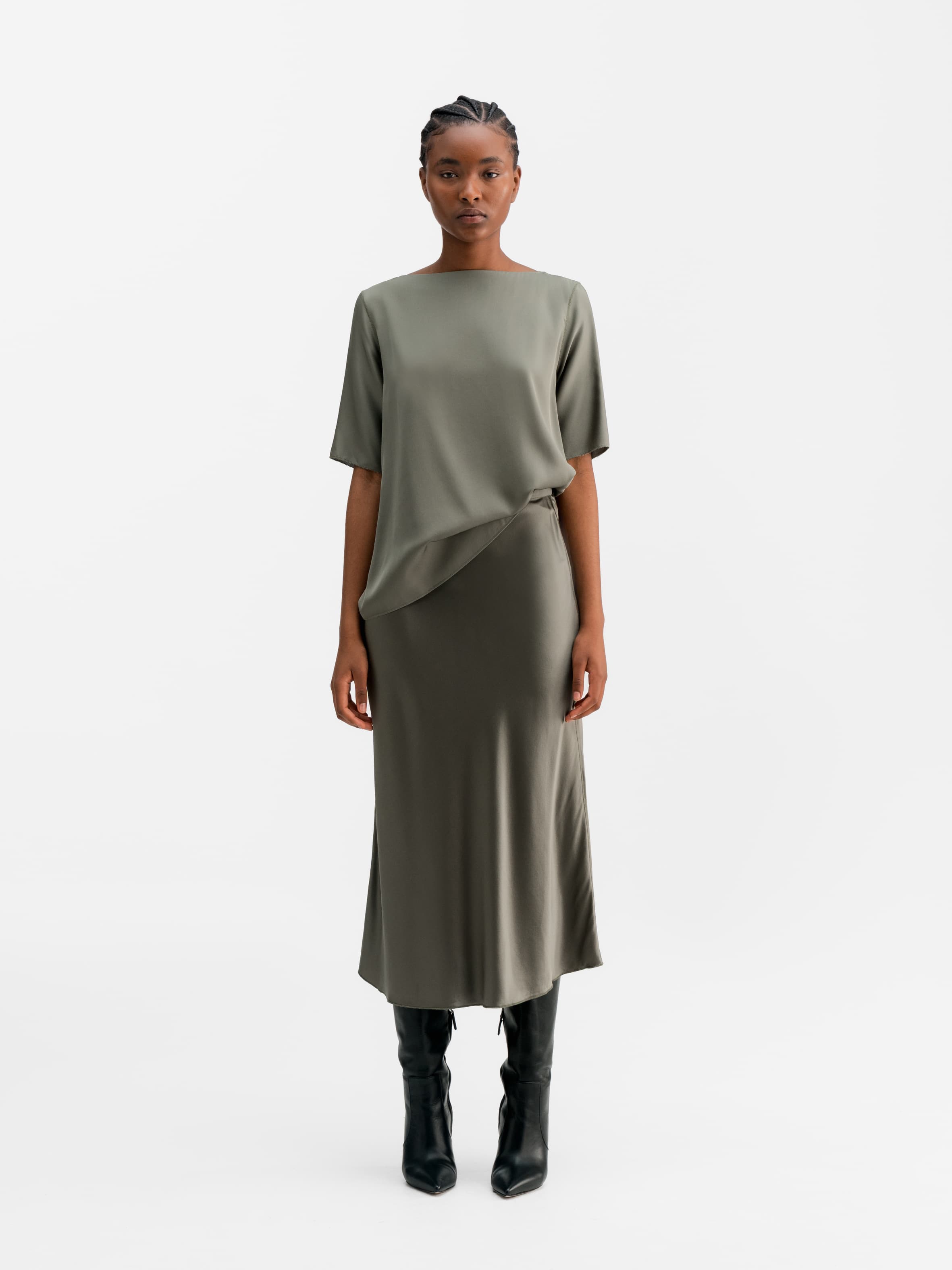 Model wearing Ahlvar Gallery Hana satin silk skirt light military