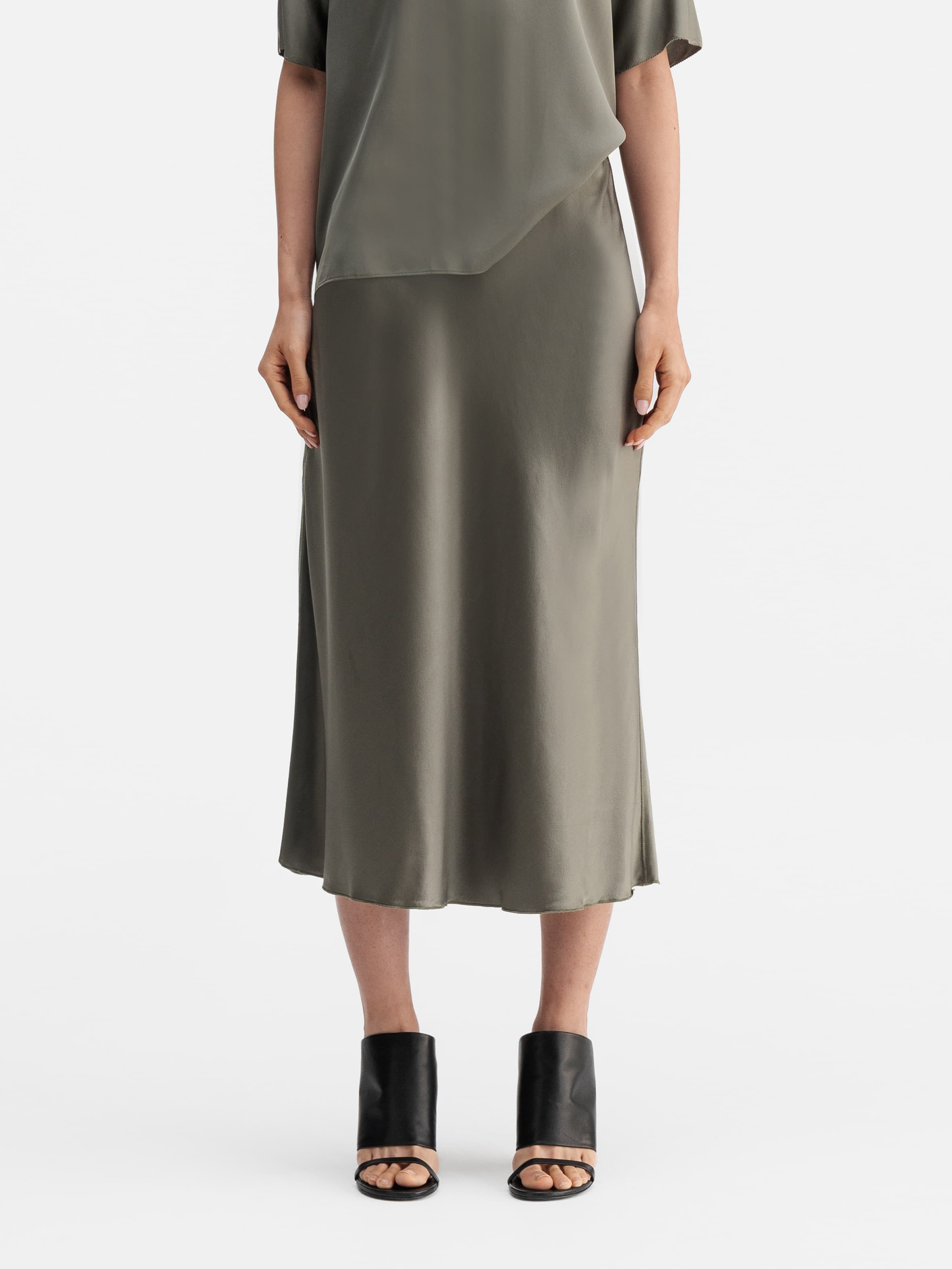 Model wearing Ahlvar Gallery Hana satin silk skirt light military
