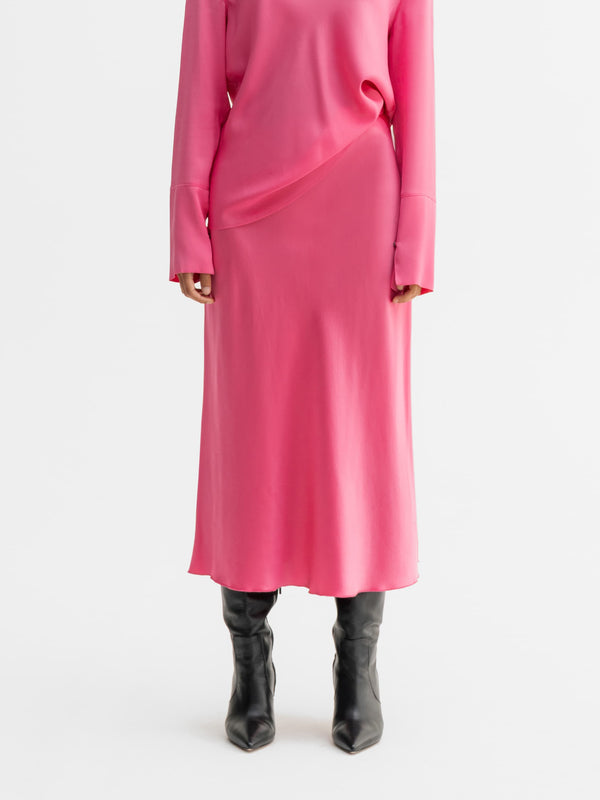 Model wearing Ahlvar Gallery Hana satin silk skirt in Pink