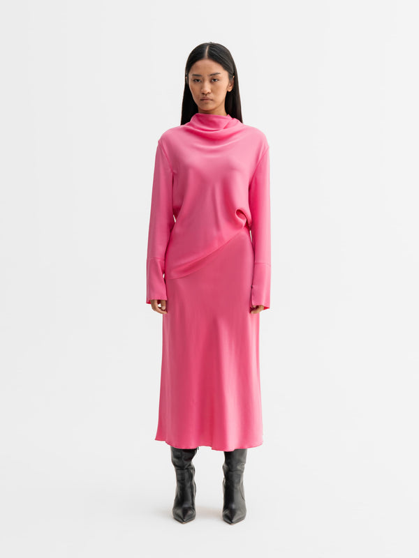 Model wearing Ahlvar Gallery Hana satin silk skirt in Pink