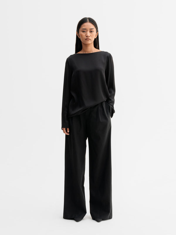 Model wearing Ahlvar Gallery Kelly silk blouse in Black