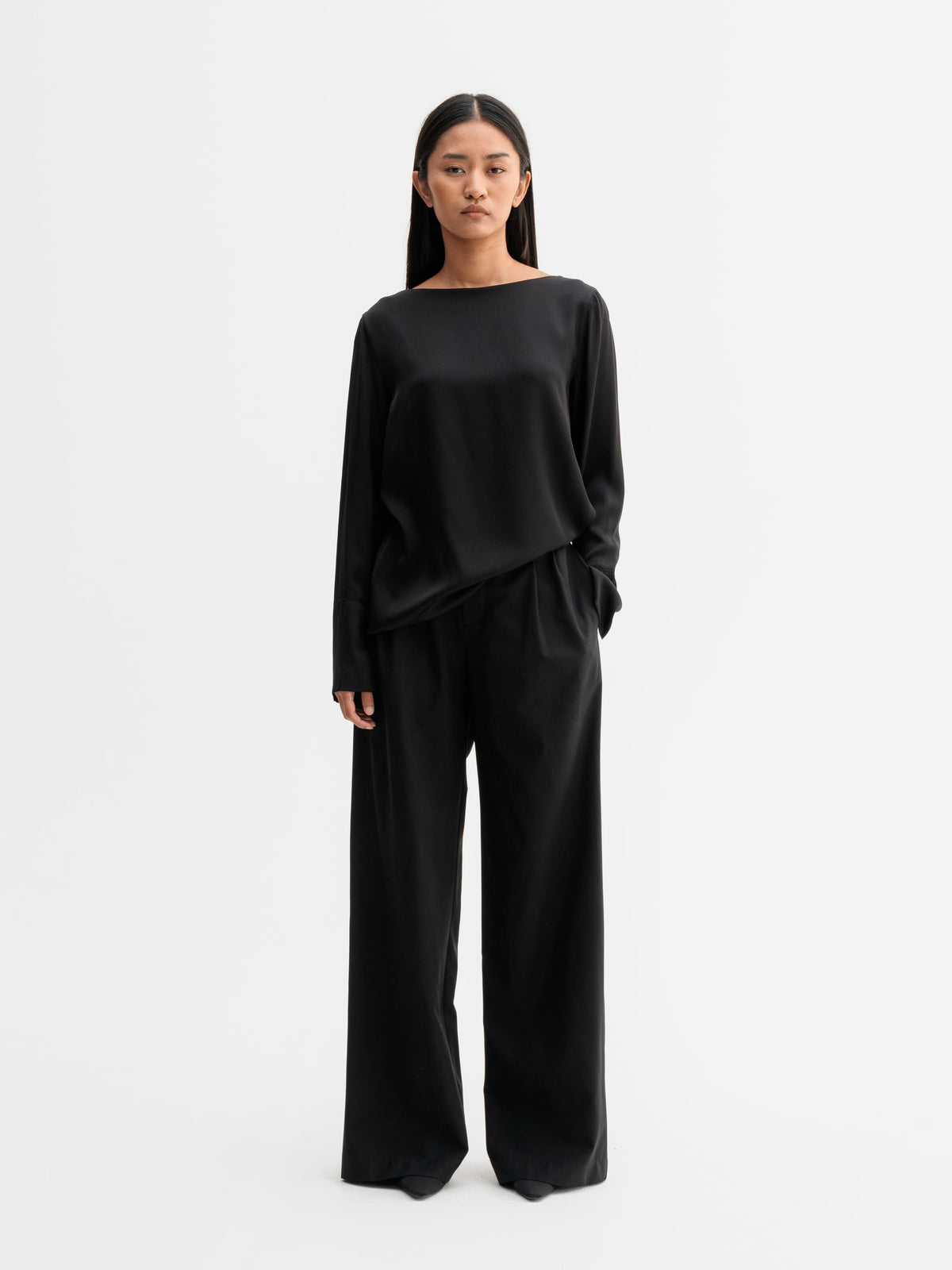 Model wearing Ahlvar Gallery Kelly silk blouse in Black