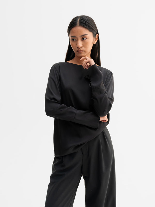 Model wearing Ahlvar Gallery Kelly silk blouse in Black