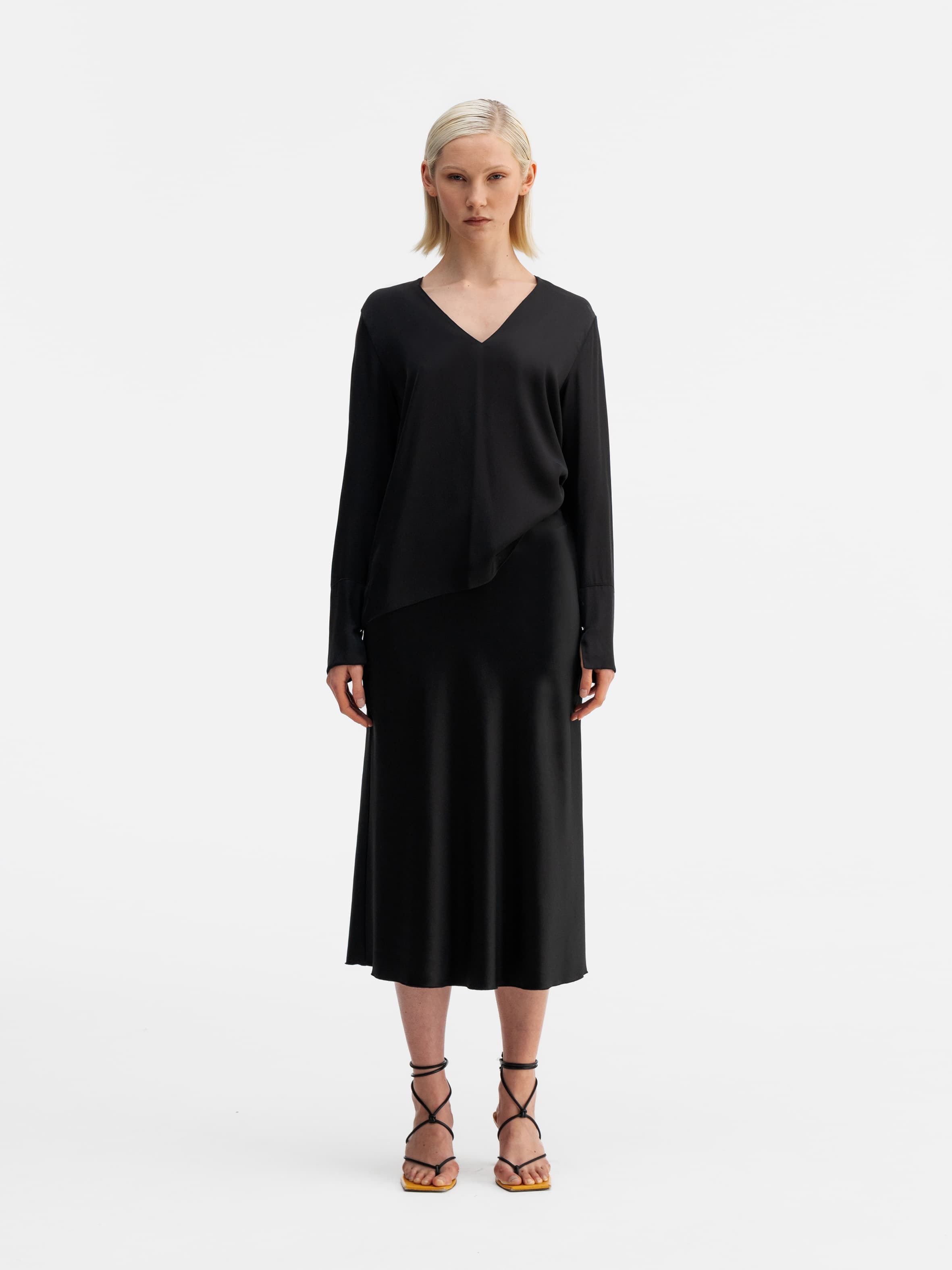 Model wearing Ahlvar Gallery Kelly v-neck silk blouse black